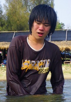 Wet fun in pullover and blue jeans swimming fully clothed